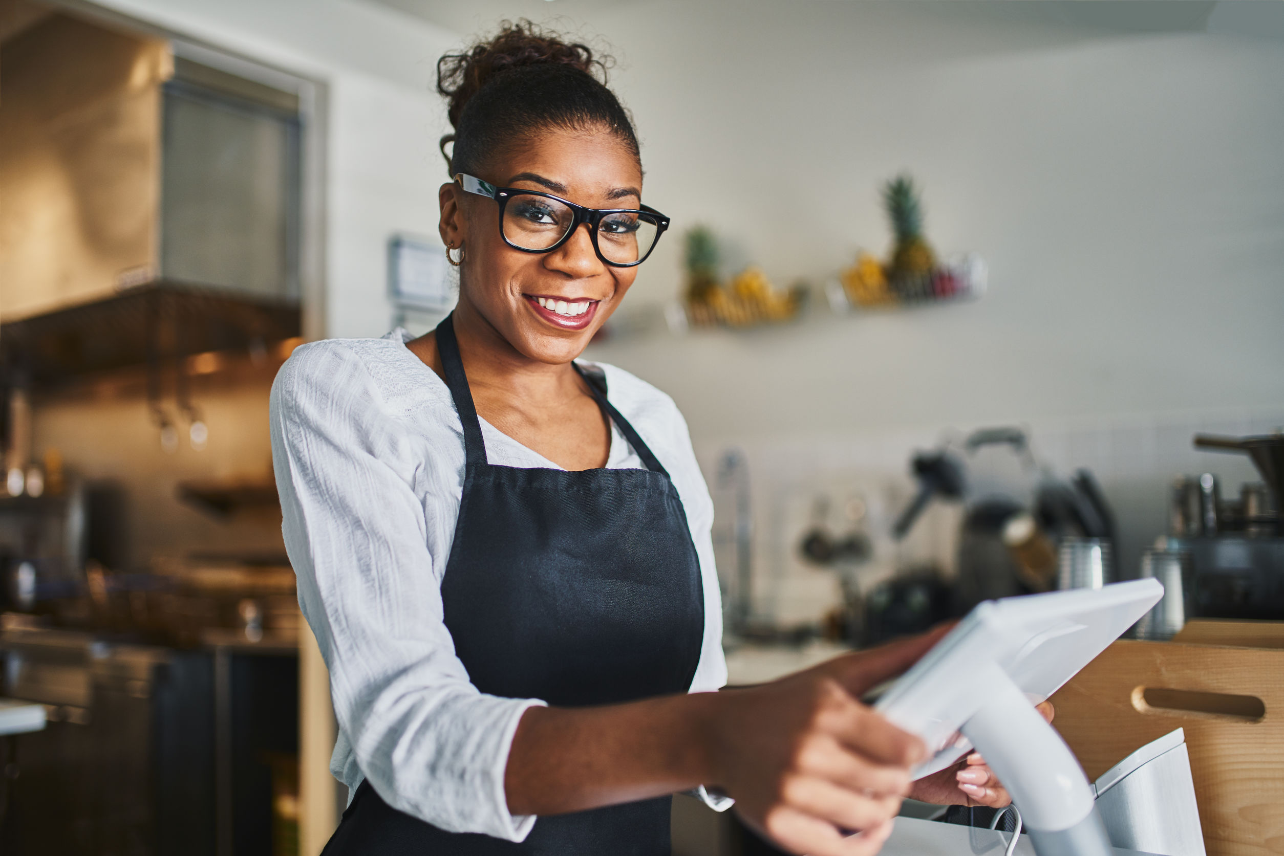 She work in a restaurant. Smiling shop Assistant. Ready to take your orders.